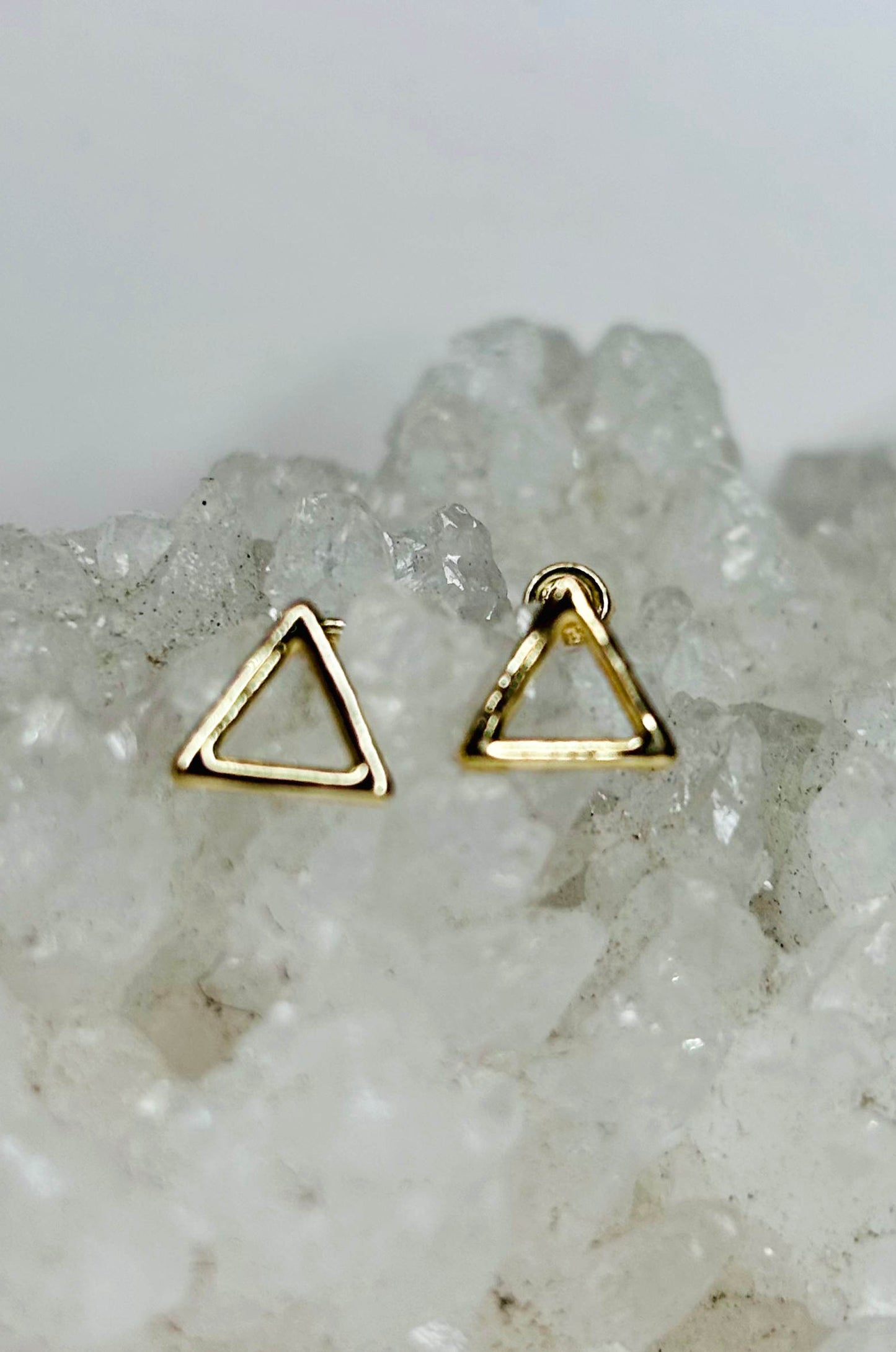 Aretes triángulo en oro amarillo 10k con cerradura de bebé
